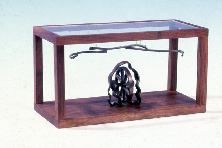 WHEEL AND BONES, 1985, bronze, walnut and plexiglass, 8" x 4" x 4", Private Collection