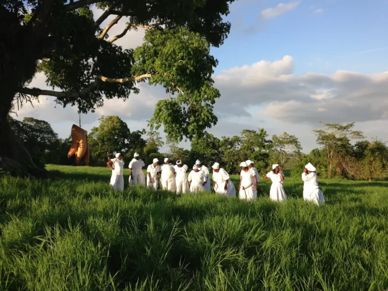 Melda and her group with De Hangin' of Phibbah sculpture, 2015, in a field in St Ann for Laura's Paddlin' Spirit documentary 